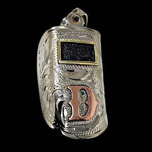 May include: Silver-toned pendant with intricate floral and scroll engraving. Features a rectangular black inset framed in gold, and a copper-colored letter "B" with a silver outline. The pendant has a loop at the top for a chain.