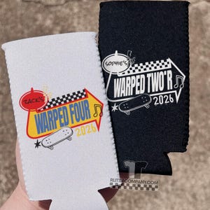 May include: Two beverage insulators, one white and one black, with the text "WARPED FOUR 2026" and "WARPED TWO'R 2026" respectively. Each features a skateboard graphic and a checkered flag design. The white insulator has a red circle with the name "Zack's".