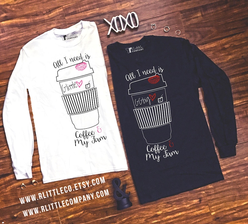 May include: Two long-sleeved shirts with a coffee cup graphic and the text "All I need is Coffee & My Jam". The shirts are white and navy blue. The text on the white shirt is in black and the text on the navy blue shirt is in white.
