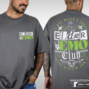 May include: A dark gray t-shirt with a green and white graphic print that says "Elder Emo Club" and "It was never a phase".