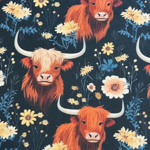 May include: A repeating pattern featuring orange Highland cows with large horns and shaggy fur, set against a dark navy background. The design includes yellow and white floral accents and blue foliage.