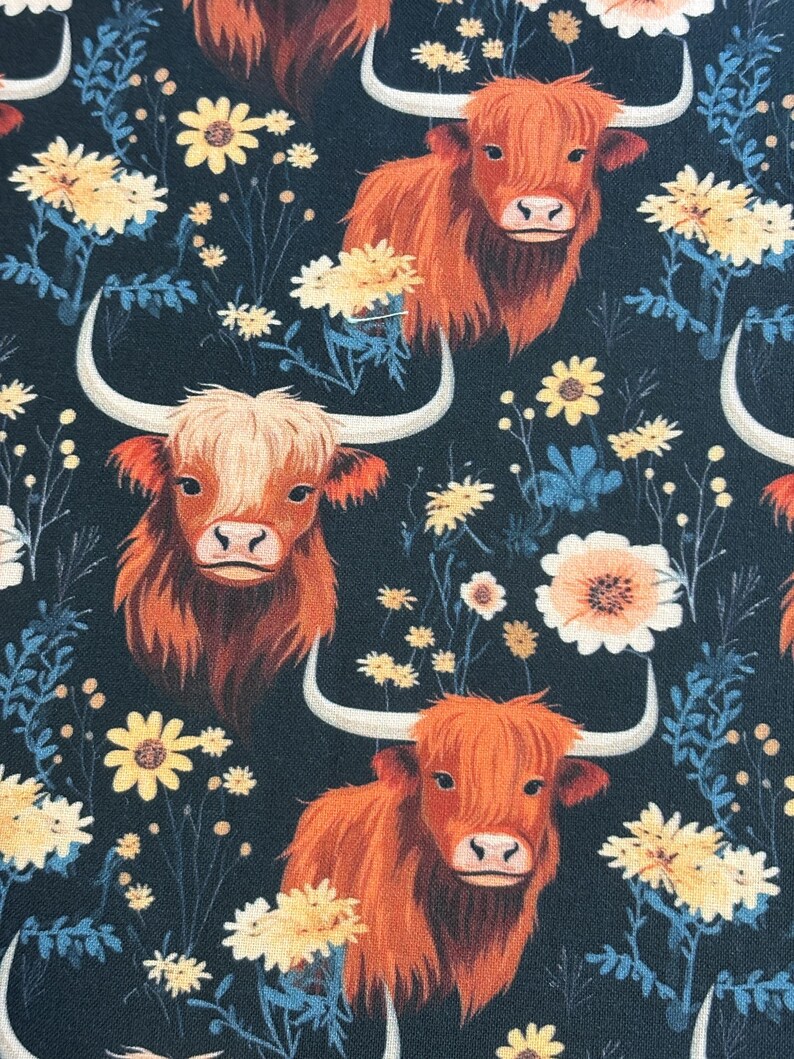 May include: A repeating pattern featuring orange Highland cows with large horns and shaggy fur, set against a dark navy background. The design includes yellow and white floral accents and blue foliage.