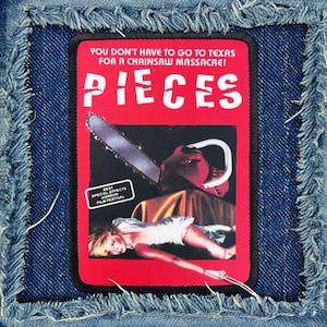 May include: A red and black iron-on patch with the text "YOU DON'T HAVE TO GO TO TEXAS FOR A CHAINSAW MASSACRE! PIECES" and a graphic of a chainsaw and a woman lying on a bed. The text "BEST SPECIAL EFFECTS HORROR FILM FESTIVAL" is in a white rectangle at the bottom left corner of the patch.