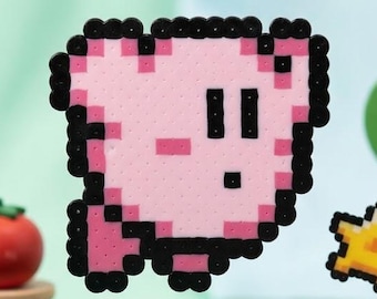 May include: A pixel art figure of a pink character with black outlines, positioned above a small orange round creature. A yellow star-shaped piece floats nearby. The scene includes a green felt tree with fruit and a red tomato on a stand.