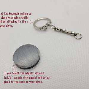 Fridge magnet, featuring a round ceramic disk magnet and a metal keychain attachment.