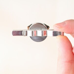 May include: A silver-toned key with a star-shaped head and a flat, rectangular handle.