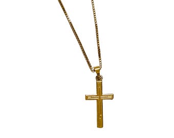 May include: A gold chain necklace with a gold cross pendant.