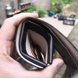 Wallet with squeeze frame coin pouch and space for notes.