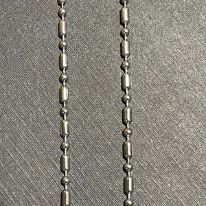 May include: Two silver chains with round and rectangular links.