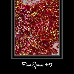 May include: Close-up of a red and gold glitter background with a white background in the upper left corner. The text "Fine Spun #13" is written below the image.