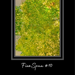 May include: A close-up of a green and gold glitter texture. The glitter is fine and sparkly, creating a shimmering effect. The text "Fine Spun #10" is written below the image.