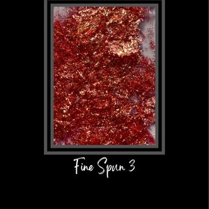May include: A close-up of a red and gold fine spun glitter. The glitter is in a square frame with the text "Fine Spun 3" below the frame.