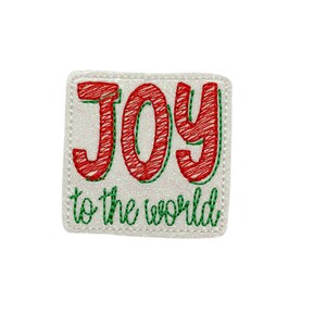 May include: White glitter background with a red embroidered word "JOY" and green embroidered text "to the world".