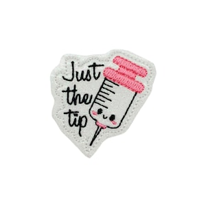 May include: White embroidered patch with a pink and white syringe with a smiling face and the text "Just the tip".