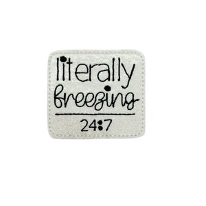 May include: White iron-on patch with black text that reads "literally freezing 24/7".