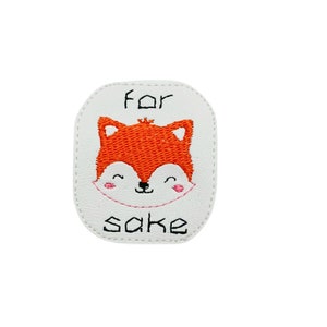 May include: White patch with an orange fox face and the text "for sake" in black.