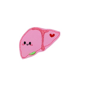 May include: A pink felt patch with an embroidered cartoon liver with a smiling face, a green gallbladder, and a red heart.