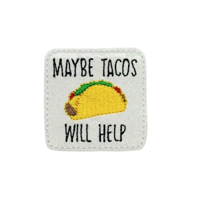 May include: A square, white patch with the text "MAYBE TACOS WILL HELP" in black lettering. A yellow taco with green and red accents is embroidered below the text. The patch has a glittery, textured appearance.