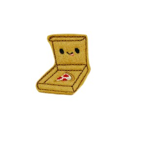 May include: A yellow felt pizza box with a smiling face and a slice of pizza inside.