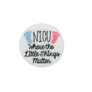 May include: White circle embroidered patch with the text "NICU Where the Little Things Matter" and two small footprints, one blue and one pink.
