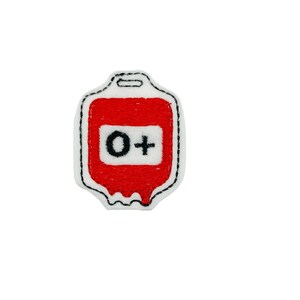 May include: Red embroidered patch shaped like a blood bag with a white label that says "O+"