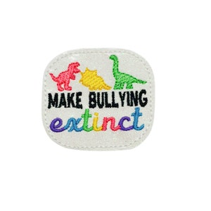 May include: White iron-on patch with a rainbow-colored dinosaur design and the text "Make Bullying Extinct".