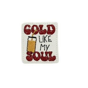 May include: Embroidered patch with red text that reads "COLD LIKE MY SOUL" and a yellow cartoon image of a glass with a straw.
