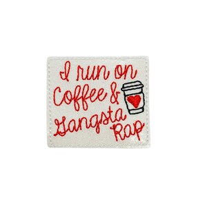 May include: White embroidered patch with red text that reads "I run on coffee & gangsta rap". A black and white illustration of a coffee cup with a red heart inside is next to the text.