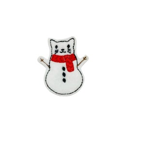 May include: White felt snowman with a red scarf and black eyes, nose, and mouth. The snowman has a cat face with whiskers.