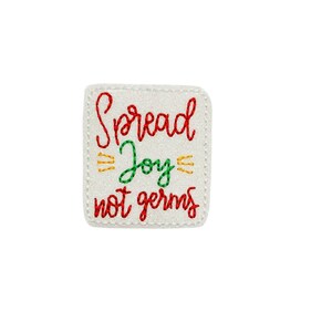 May include: White square patch with red, green, and yellow stitching. The text reads "Spread Joy not germs".