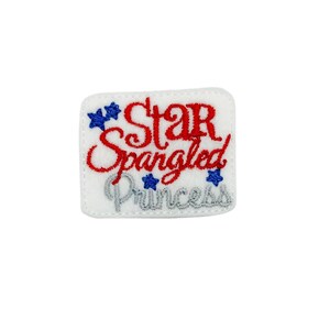 May include: White embroidered patch with red text that says "Star Spangled Princess" and blue stars.