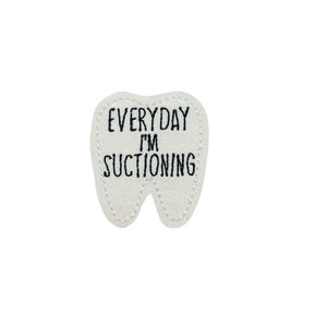 May include: White tooth-shaped patch with black text that reads "EVERYDAY I'M SUCTIONING".