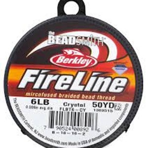 May include: A spool of FireLine mircofused braided bead thread, 6LB Crystal, 50YD. The label features the text "The Beadsmith" and "Berkley" with a red, orange, and black color scheme. The spool has a black handle.