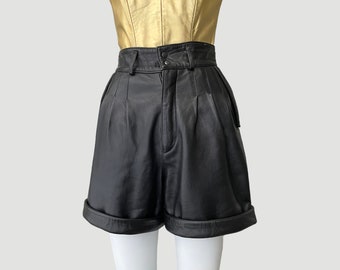 Black Leather High Waist Pleated Trouser Shorts | 90’s Vintage Smooth Leather Cuffed Midi Length Shorts w/ Adjustable Tabs  by Michael Hoban