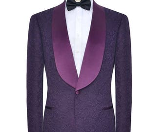May include: A purple patterned tuxedo jacket with a satin shawl collar. The jacket has a single button closure and a black bow tie.