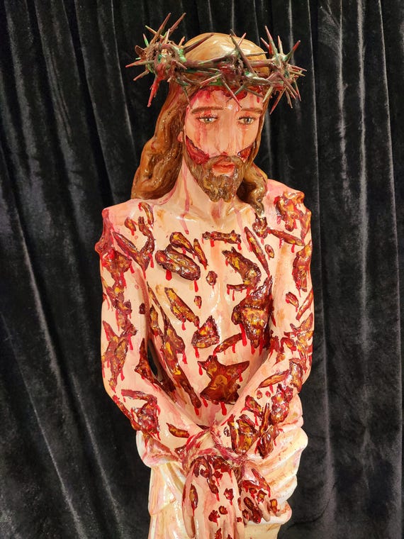 36" Scourged Jesus fiberglass statue. Comes with a crown of thorns, rope around his wrist and a purple cloak (Glorified version).