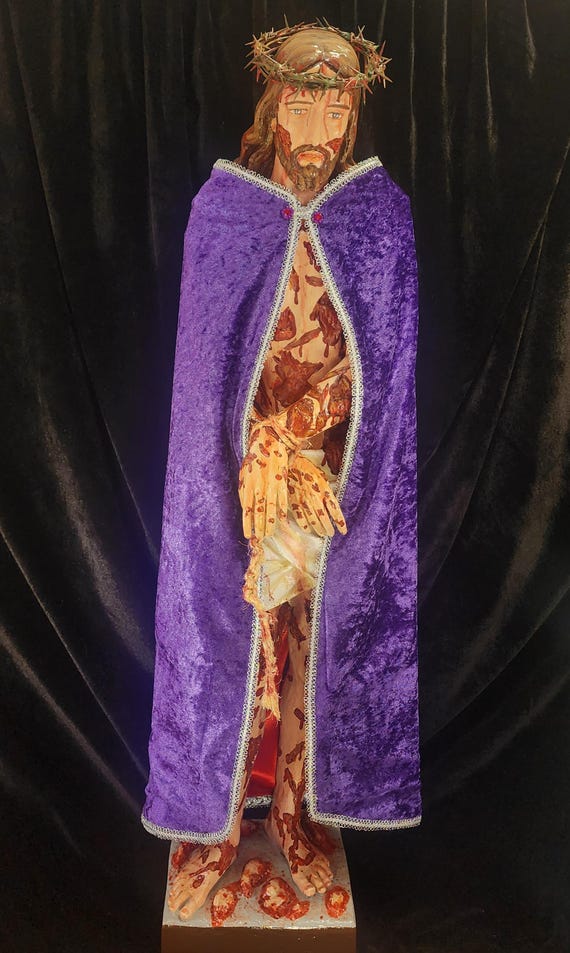 Hand-Painted 36" Scourged Jesus statue. Comes with Crown of Thorns, Rope around His wrist and a "Glorified" Scarlet/Purple Cloak.