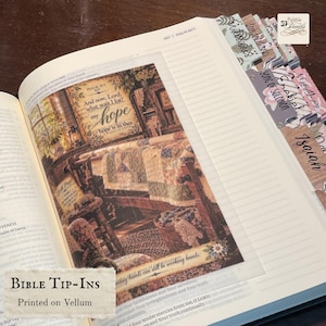 May include: A vellum bible tip-in insert featuring a printed illustration of a cozy room with a quilt, a wooden stool, and text that reads And now, Lord, what wait I for? my hope is in thee. The insert has decorative tabs for book navigation.