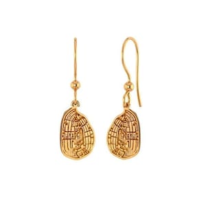 May include: Gold dangle earrings with a detailed, textured, oval-shaped design.