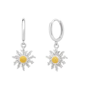 May include: A pair of silver hoop earrings with daisy pendants. Each earring features a silver hoop with a daisy charm. The daisy has a yellow center and silver petals. The earrings are displayed against a white background.