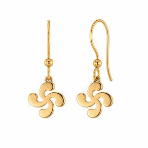 May include: A pair of gold-toned drop earrings featuring a four-armed curved cross pendant. Each earring is suspended from a simple hook wire with a small spherical bead accent above the charm, showcasing a polished, smooth metallic finish.