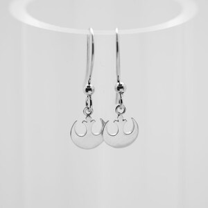 May include: A pair of silver earrings with a Rebel Alliance symbol pendant.