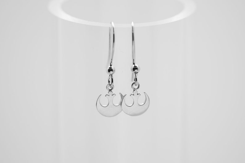 May include: A pair of silver earrings with a Rebel Alliance symbol pendant.