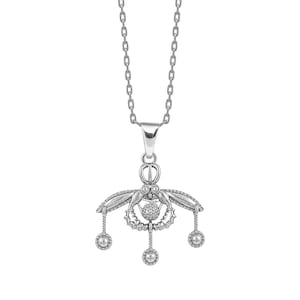 May include: A silver-colored pendant necklace. The pendant features a symmetrical design with a central floral element, two wing-like structures, and three dangling spherical accents. The necklace chain is also silver.