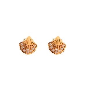 May include: A pair of gold-tone earrings shaped like seashells with clear crystal accents.