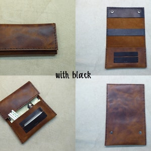 May include: A brown leather cigarette case with black stitching and a black flap. The case is open to reveal a black interior with two slots for cigarettes. The case is closed in the other images.