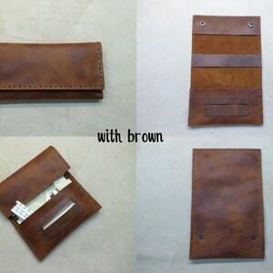 May include: A brown leather cigarette case with a flap closure and stitching detail. The case is open to reveal a compartment for cigarettes and a smaller compartment for rolling papers.