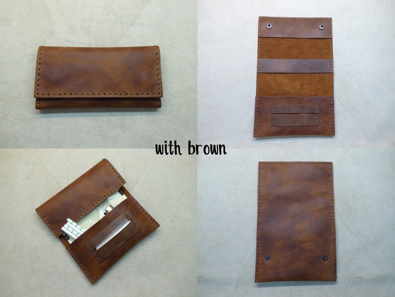 May include: A brown leather cigarette case with a flap closure and stitching detail. The case is open to reveal a compartment for cigarettes and a smaller compartment for rolling papers.