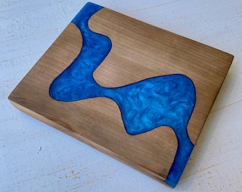 Charcuterie board-Live edged Black Ash inlaid with a river of swirly blue epoxy resin