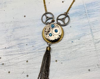 Handmade Steampunk pendant necklace made from up-cycled clock gears, bejeweled vintage watch movement, and bronze tassel